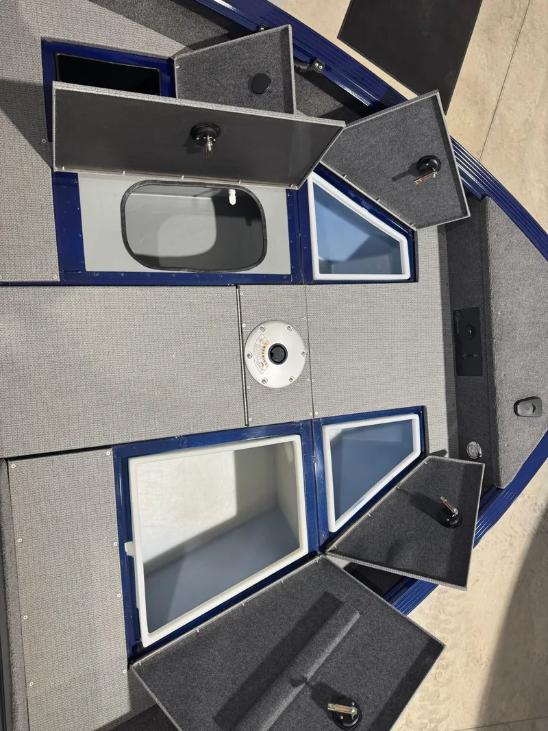 Slide: The Image of 2024 G3 AV18SF VINYL boat interior with open storage compartments and seating area. - 18