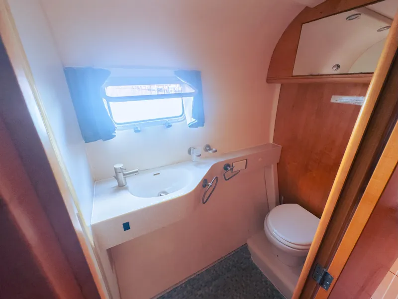 Slide: The Image of Compact luxury bathroom in a 2005 custom performance model, featuring sink and toilet. - 10