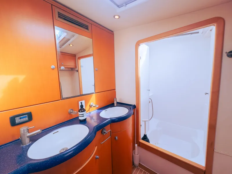 Slide: The Image of Luxurious yacht bathroom with dual sinks, wooden cabinetry, and spacious shower, 2005 model. - 12