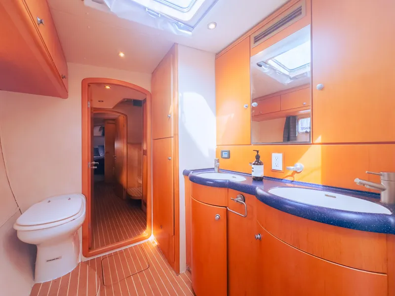 Slide: The Image of Luxurious yacht bathroom with wooden cabinetry, dual sinks, and modern fixtures, 2005 custom model. - 13