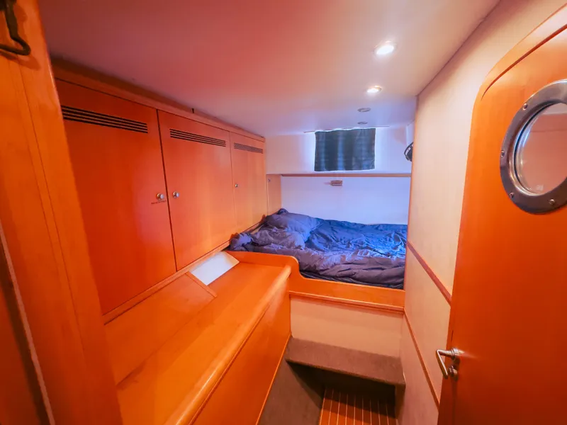 Slide: The Image of Luxurious 2005 custom yacht cabin with wooden interiors and cozy bedding. - 14