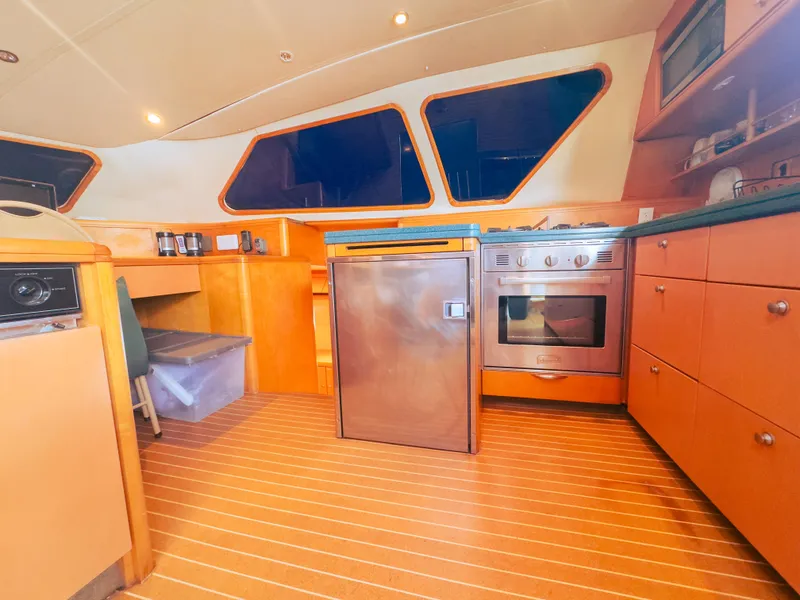 Slide: The Image of Luxurious yacht kitchen with modern appliances, wooden cabinetry, and sleek design, 2005 Custom model. - 15