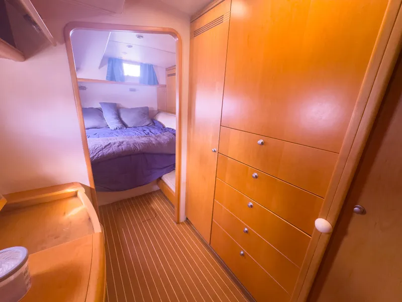 Slide: The Image of Luxurious 2005 custom yacht interior with cozy bedroom and elegant wooden cabinetry. - 17