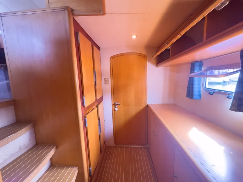 Slide: The Image of Luxurious 2005 custom yacht interior with wooden cabinetry and natural light. - 19
