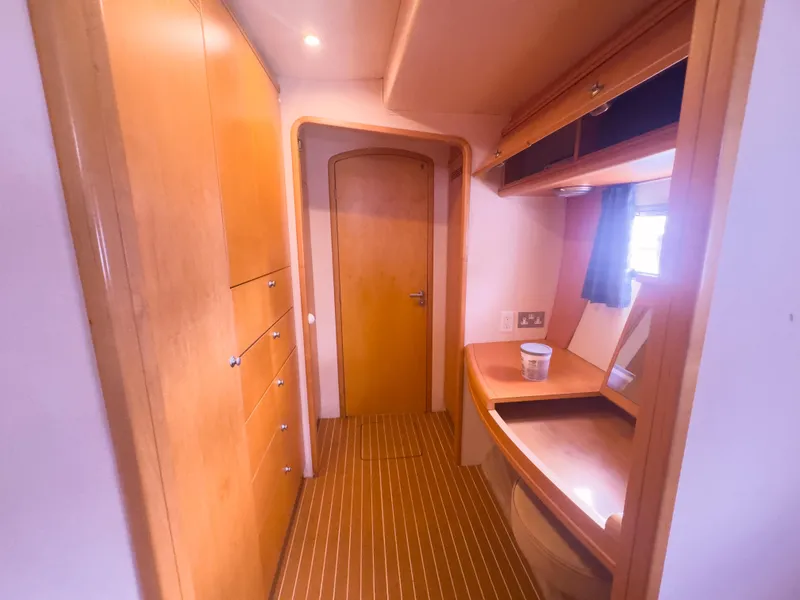 Slide: The Image of Luxurious wooden interior of a 2005 custom luxury performance model, featuring cabinets and a vanity. - 20