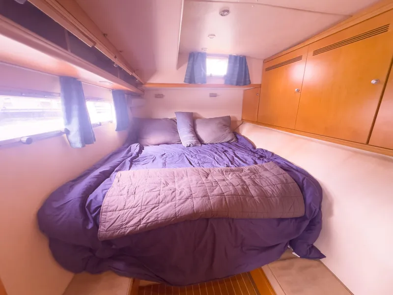Slide: The Image of Luxurious 2005 custom yacht bedroom with cozy bedding and wooden cabinetry. - 23