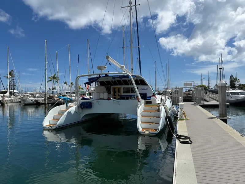 Slide: The Image of Luxury performance catamaran docked at marina, clear sky, 2005 model. - 25