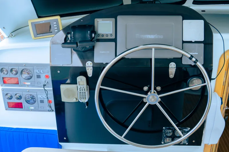 Slide: The Image of Control panel of a 2005 custom luxury performance boat with steering wheel and navigation instruments. - 6