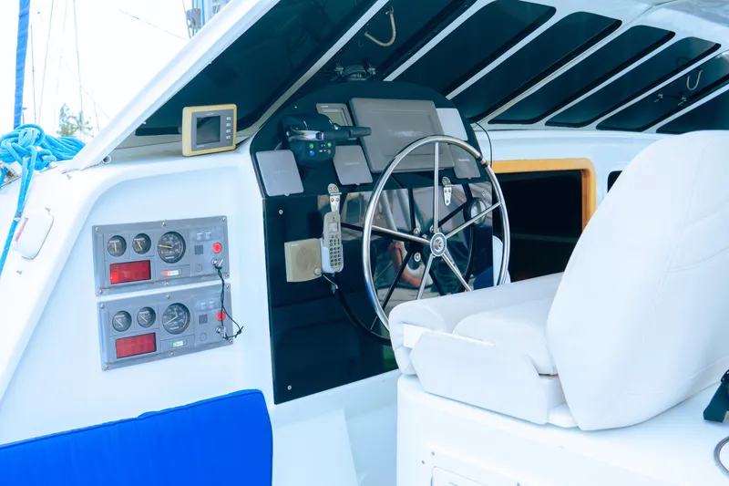 Slide: The Image of Luxury yacht cockpit with steering wheel, control panels, and white seating, 2005 model. - 7