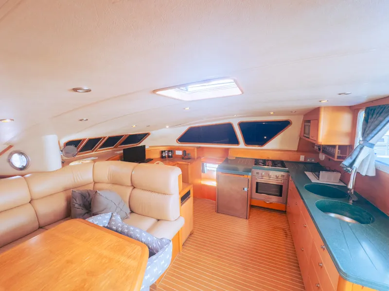Slide: The Image of Luxurious yacht interior with modern kitchen and comfortable seating, 2005 Custom Luxury Performance model. - 8