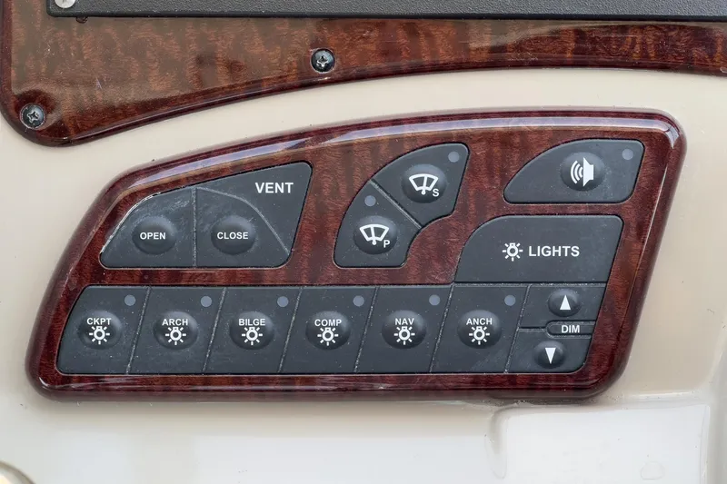 Slide: The Image of Control panel of a 2007 Sea Ray 310 Sundancer boat with various function buttons. - 20