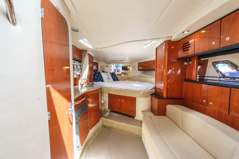 Slide: The Image of Luxurious interior of 2007 Sea Ray 310 Sundancer yacht with wood cabinetry and cozy seating. - 23