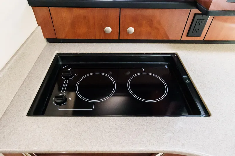 Slide: The Image of Built-in stovetop on 2007 Sea Ray 310 Sundancer yacht kitchen counter. - 28