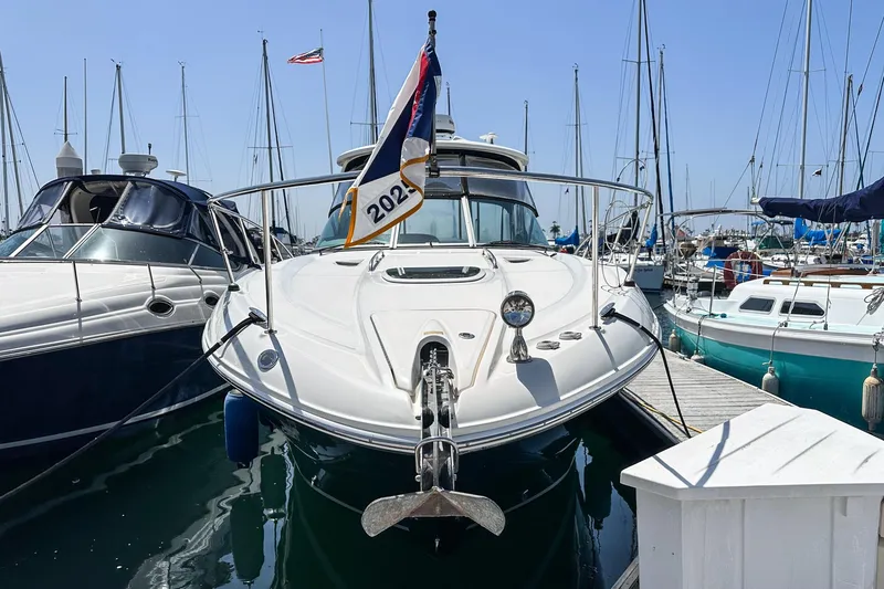 Slide: The Image of 2007 Sea Ray 310 Sundancer docked at marina with sailboats in background. - 3