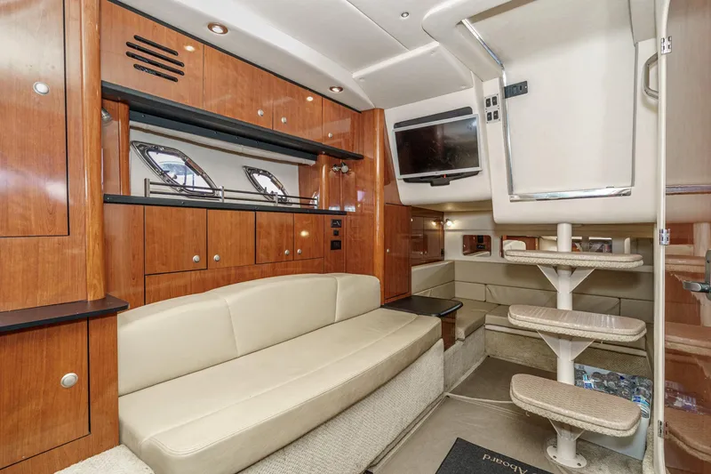 Slide: The Image of Luxurious interior of 2007 Sea Ray 310 Sundancer yacht with wood cabinetry and beige seating. - 31