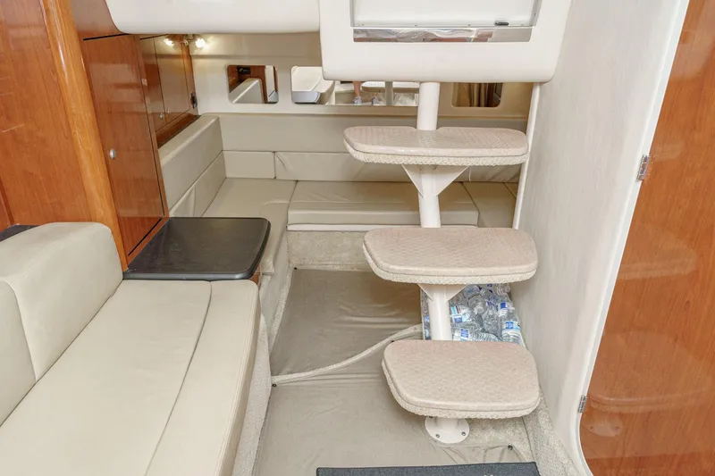 Slide: The Image of 2007 Sea Ray 310 Sundancer cabin interior with beige seating and compact staircase. - 32