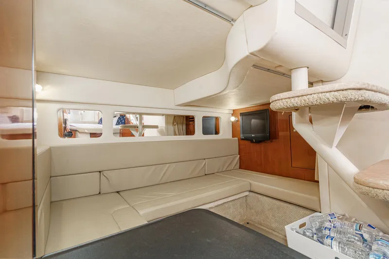 Slide: The Image of Interior of 2007 Sea Ray 310 Sundancer yacht with beige seating and TV. - 33