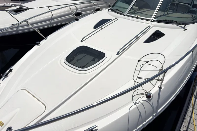 Slide: The Image of 2007 Sea Ray 310 Sundancer boat deck with sleek design and railing. - 4