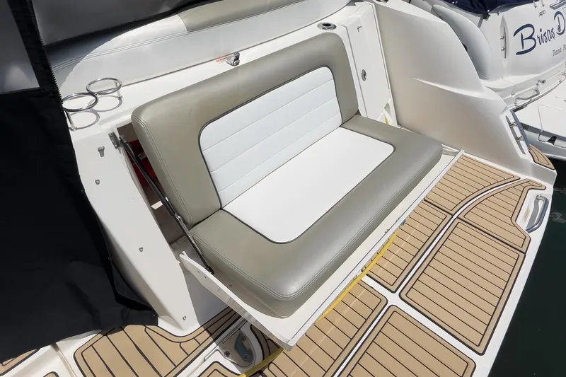 Slide: The Image of 2007 Sea Ray 310 Sundancer boat seat with cup holders on teak deck. - 8