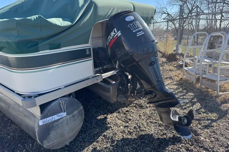Slide: The Image of Covered 2003 Odyssey MILLENIUM pontoon boat with Suzuki 115 outboard motor, parked outdoors. - 10