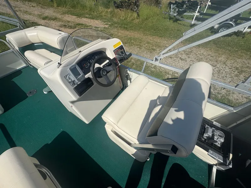 Slide: The Image of 2003 Odyssey MILLENIUM boat interior with white seating and green carpet. - 3