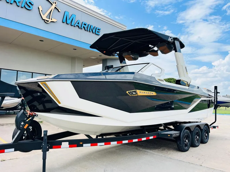 Slide: The Image of 2026 Nautique Super Air Nautique G25 Paragon boat on trailer at dealership. - 1
