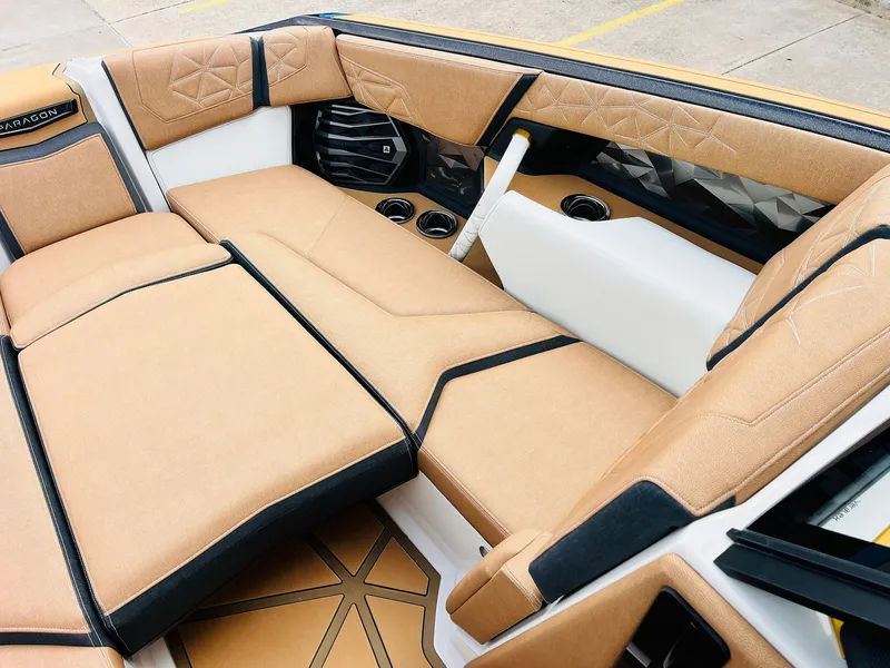 Slide: The Image of 2026 Nautique Super Air Nautique G25 Paragon interior with luxurious tan seating and modern design. - 13
