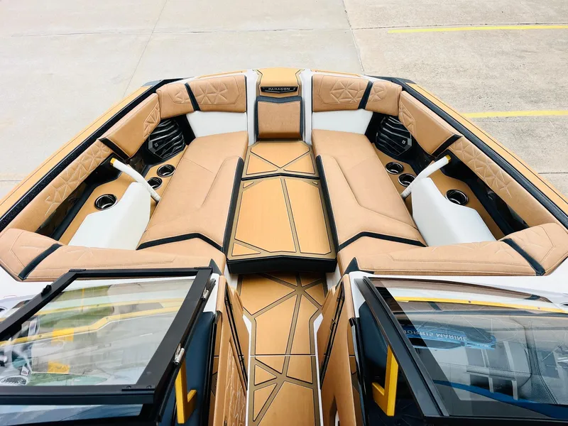 Slide: The Image of 2026 Nautique Super Air Nautique G25 Paragon boat interior with luxurious tan seating. - 14