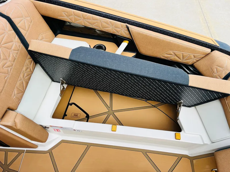 Slide: The Image of 2026 Nautique Super Air Nautique G25 Paragon interior storage compartment with tan upholstery. - 18