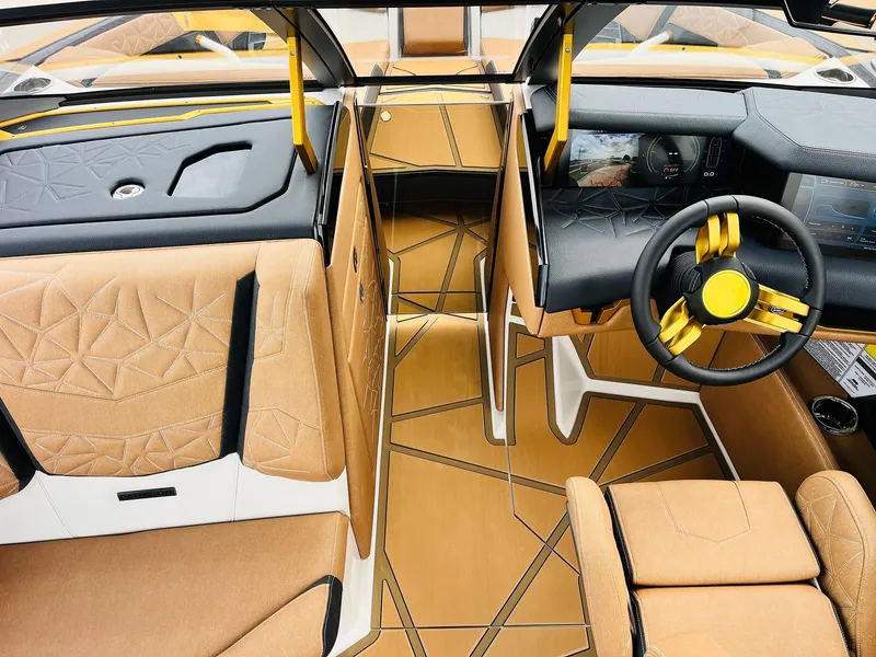 Slide: The Image of 2026 Nautique Super Air Nautique G25 Paragon interior with luxurious tan and black design. - 21