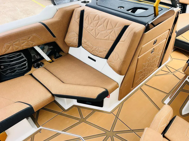 Slide: The Image of Luxurious interior of 2026 Nautique Super Air Nautique G25 Paragon with tan upholstery and geometric patterns. - 29