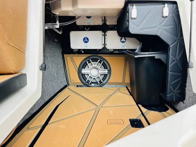 Slide: The Image of 2026 Nautique Super Air Nautique G25 Paragon interior with advanced audio system and storage. - 31