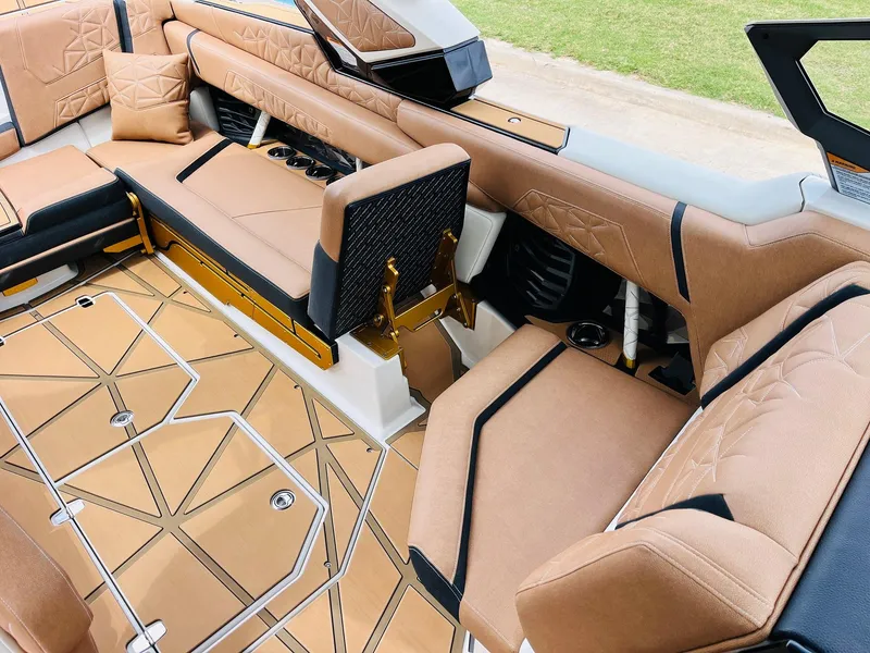 Slide: The Image of Luxurious interior of 2026 Nautique Super Air Nautique G25 Paragon with tan upholstery. - 35