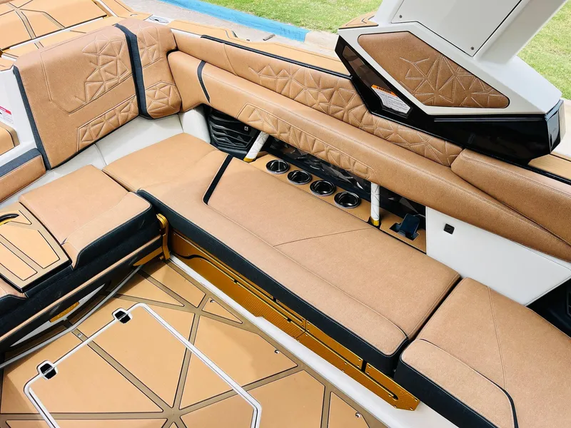 Slide: The Image of Luxurious interior of 2026 Nautique Super Air Nautique G25 Paragon with tan upholstery. - 36