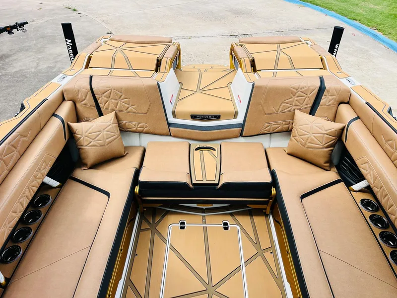 Slide: The Image of Luxurious interior of 2026 Nautique Super Air Nautique G25 Paragon boat with tan seating. - 38