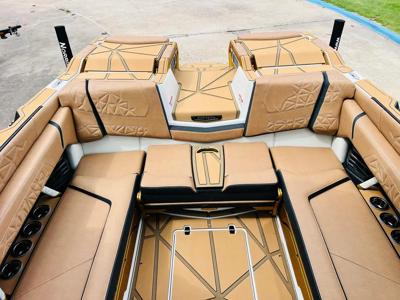 Slide: The Image of Luxurious interior of 2026 Nautique Super Air Nautique G25 Paragon boat, featuring tan upholstery. - 39