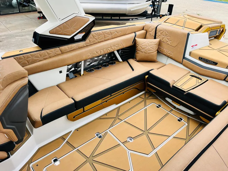 Slide: The Image of Luxurious interior of 2026 Nautique Super Air Nautique G25 Paragon boat with tan upholstery. - 48