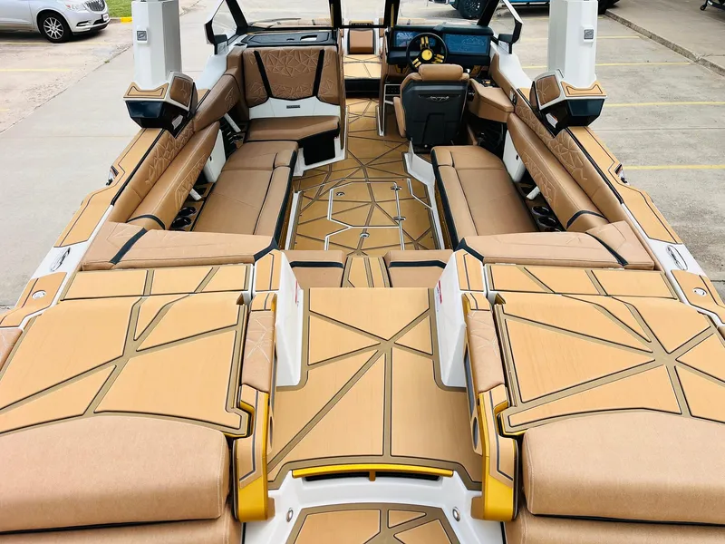 Slide: The Image of 2026 Nautique Super Air Nautique G25 Paragon interior with luxurious tan seating and modern design. - 8