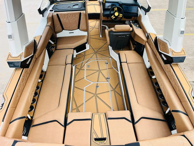 Slide: The Image of 2026 Nautique Super Air Nautique G25 Paragon interior with luxurious tan seating and modern design. - 9