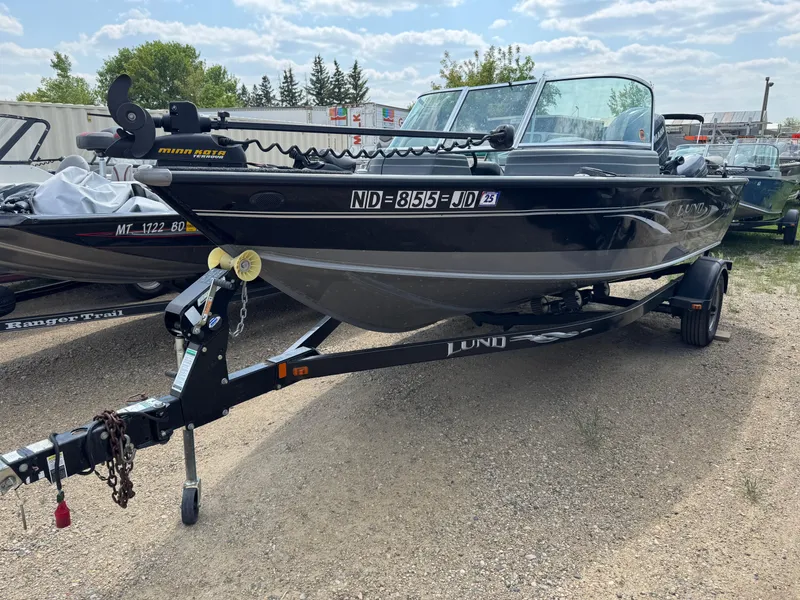 Slide: The Image of 2010 Lund 1825 Explorer boat on trailer in indoor storage facility. - 1