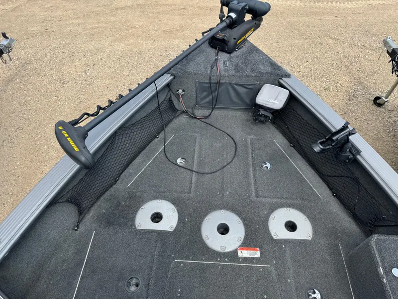 Slide: The Image of Interior of a 2010 Lund 1825 Explorer boat showing steering wheel and seating area. - 10