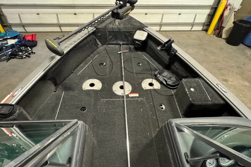 Slide: The Image of 2010 Lund 1825 Explorer boat interior with fishing rod holders and storage compartments. - 15