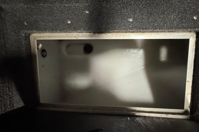 Slide: The Image of Interior compartment of a 2010 Lund 1825 Explorer boat, featuring a storage area. - 19