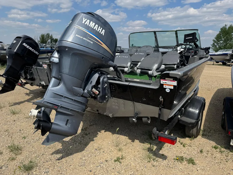 Slide: The Image of 2010 Lund 1825 Explorer boat with Yamaha outboard motor in a garage setting. - 3