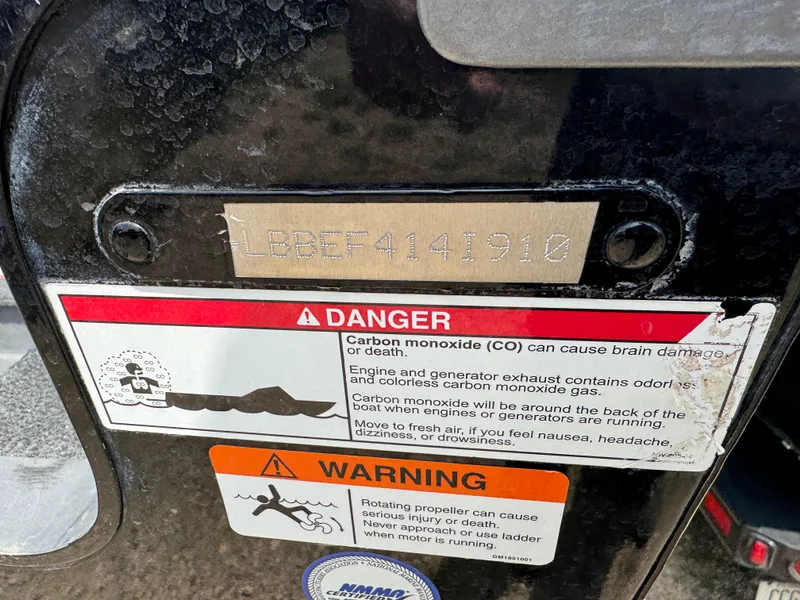 Slide: The Image of 2010 Lund 1825 Explorer boat with dual Yamaha outboard motors in a garage setting. - 5