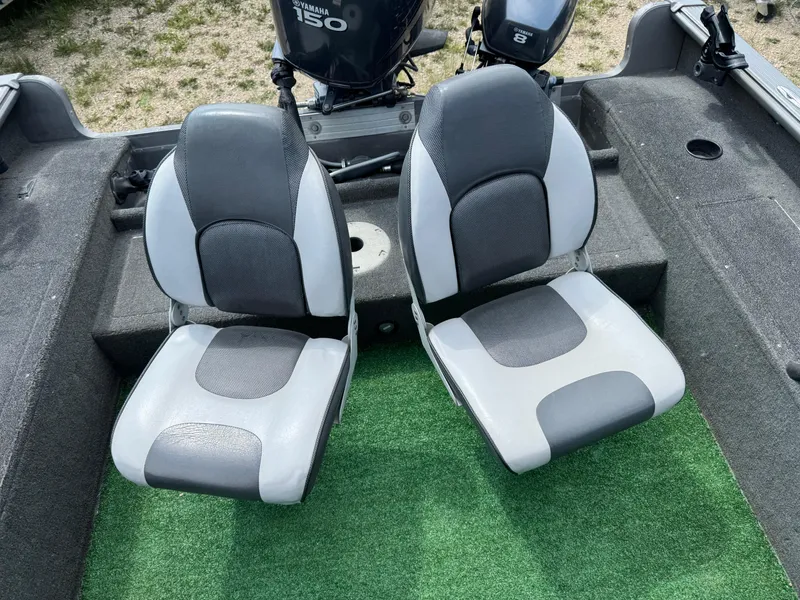 Slide: The Image of 2010 Lund 1825 Explorer boat interior with two gray and white seats. - 8