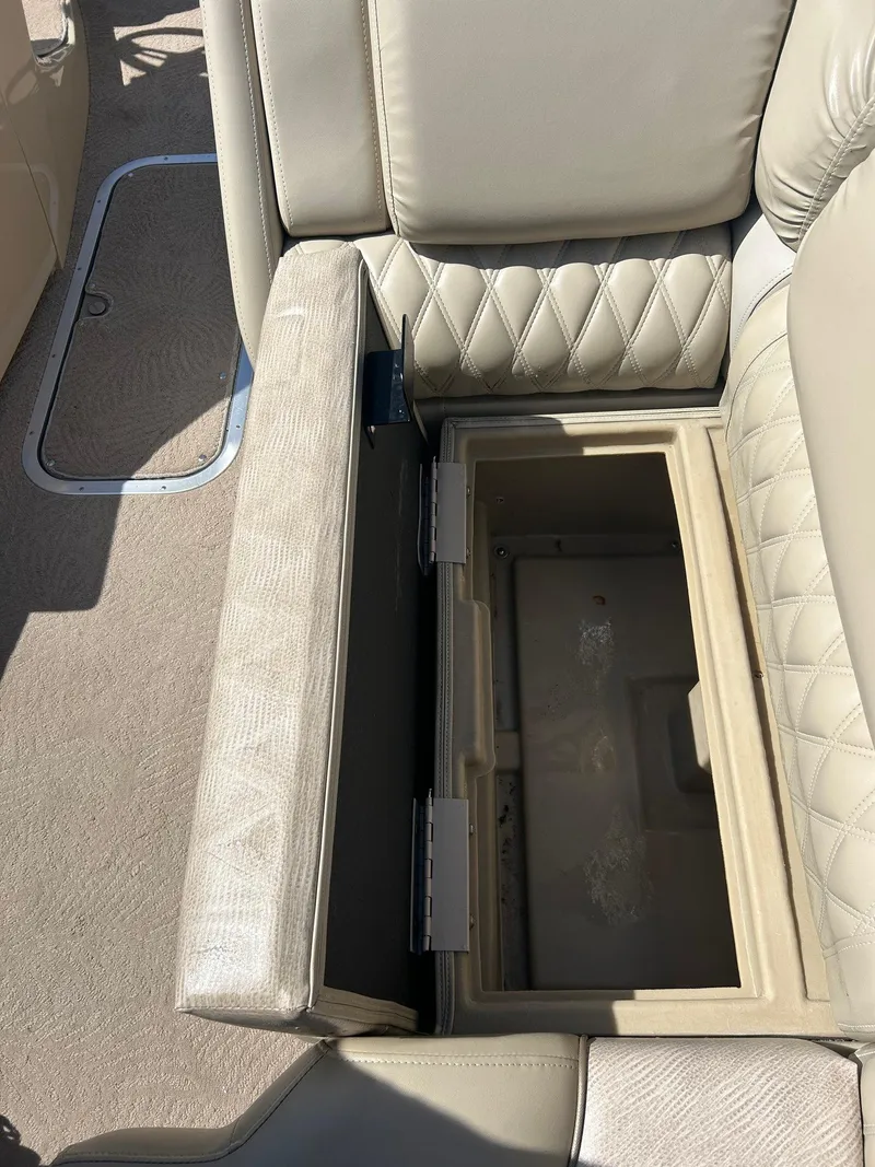 Slide: The Image of Open storage compartment in 2012 Bennington 2250RCL boat seat, beige upholstery. - 20