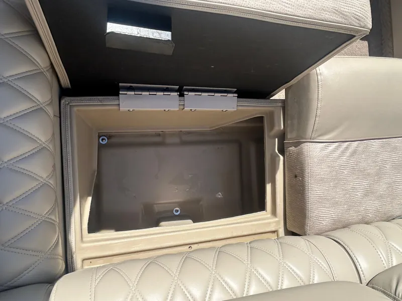 Slide: The Image of Open storage compartment in 2012 Bennington 2250RCL boat with quilted leather seating. - 26