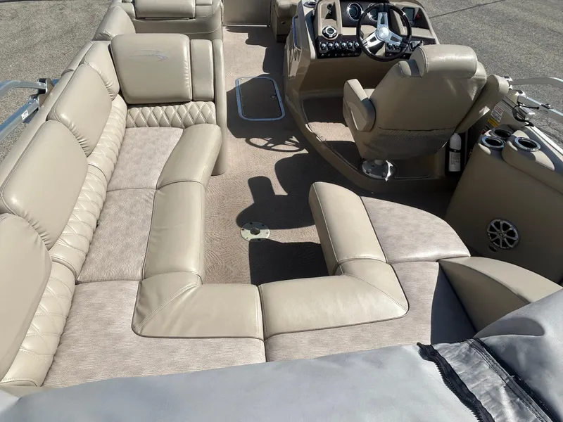 Slide: The Image of 2012 Bennington 2250RCL boat interior with beige seating and steering console. - 28