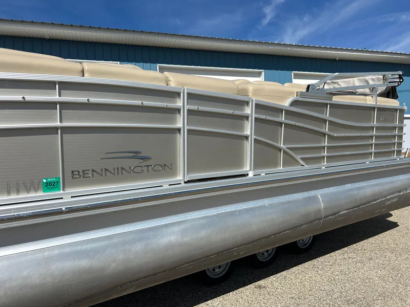 Slide: The Image of 2012 Bennington 2250RCL pontoon boat on trailer, parked outside blue garage. - 45